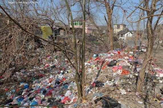 china environment crisis, garbage dump near a residential area