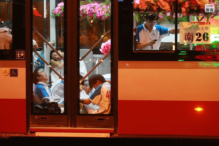 A group of students are sleeping on a bus after a national day celebration rehearsal.