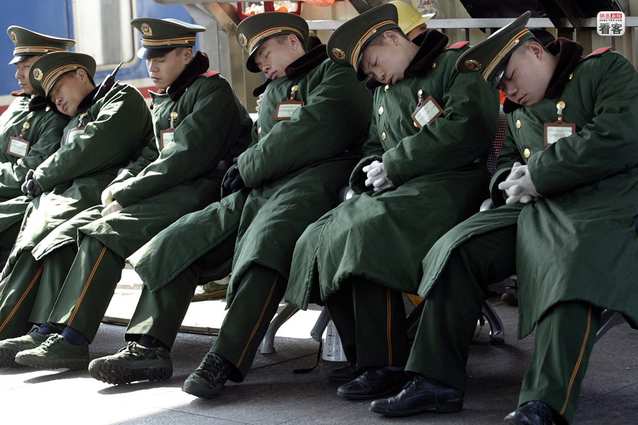 The picture is showing a group of armed policemen sleeping after long exhausting working hours on organizing and taking care of travelers in the railway station on Feb. 21, 2008