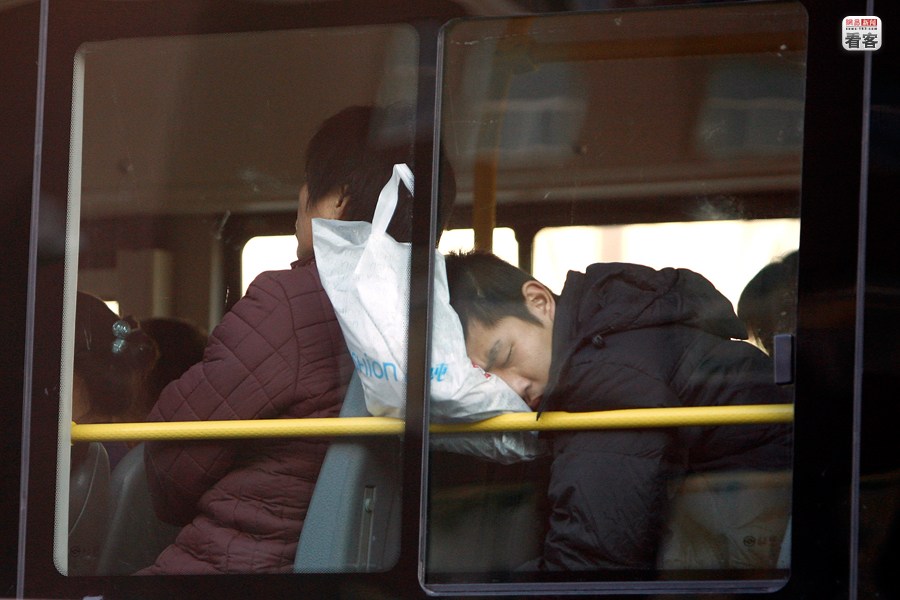 A gentleman is sleeping on a bus in Beijing