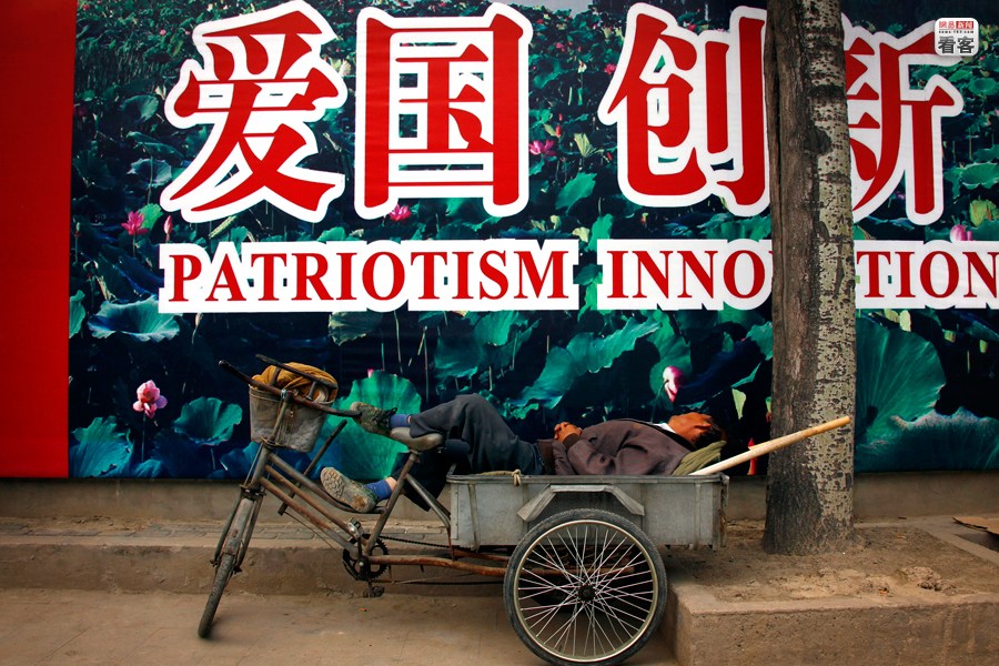A man is sleeping in his rickshaw in Beijing