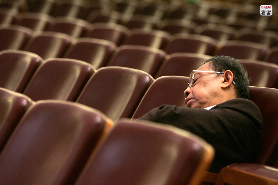 A representative of China National People's Congress (NPC) is sleeping in the Great Hall of People