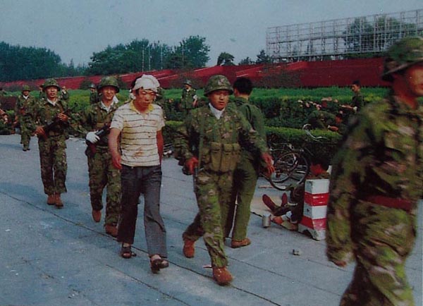 tiananmen square incident in 1989, soldiers apprehend a rioter.