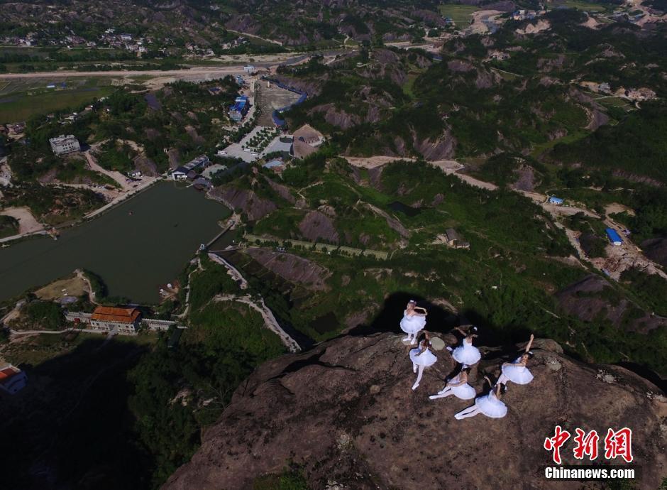 A group of ballet dancers pose on top of mountains in Shiniuzhai, Pingjiang of Hunan
