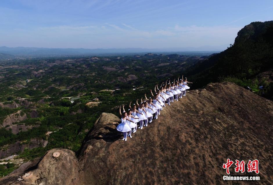 A group of ballet dancers pose on top of mountains in Shiniuzhai, Pingjiang of Hunan
