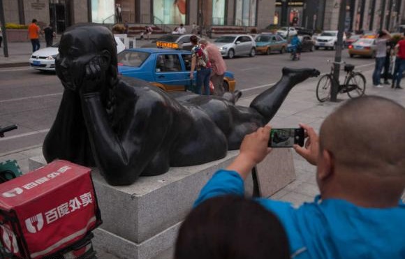This naked female status is at a shopping area of Changchun of Jilin province