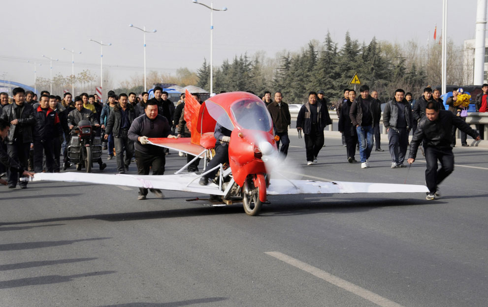 Zhang Xuelin sits inside his self-made aircraft during its test flight in Jinan