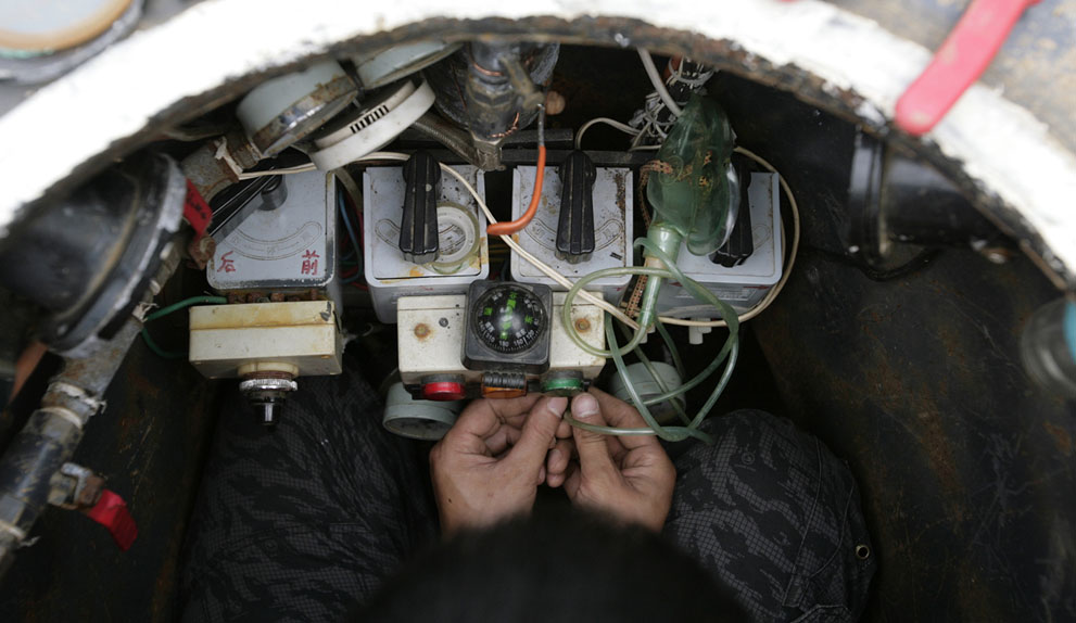 prepares to operate his homemade submarine in a lake on the outskirts of Beijing